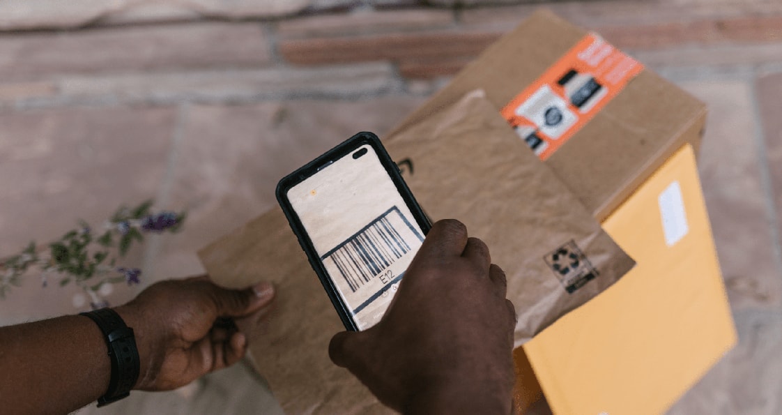 someone scanning a barcode on a package with a phone