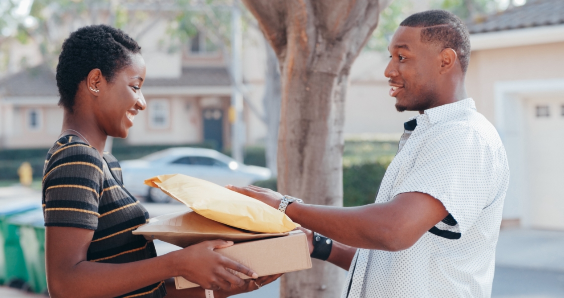 delivery person giving several parcels to someone