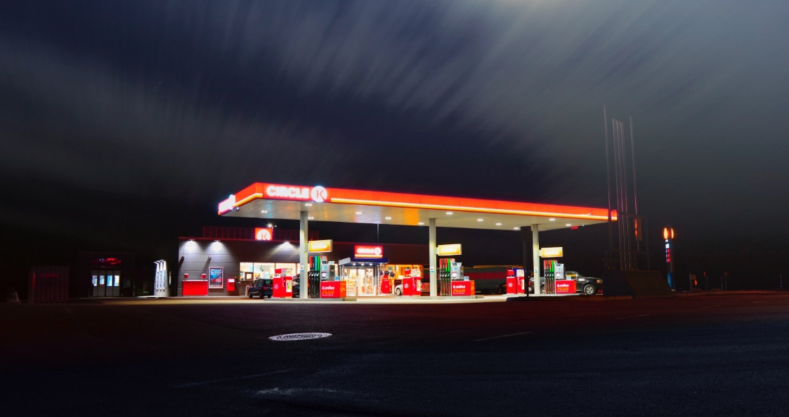 cars in a gas station at night